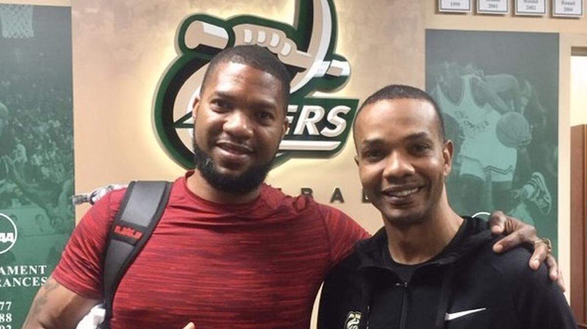 In a photo posted in 2018 by Charlotte 49ers basketball coach Ron Sanchez (right), former Charlotte 49ers basketball standout Galen Young visits his old school.