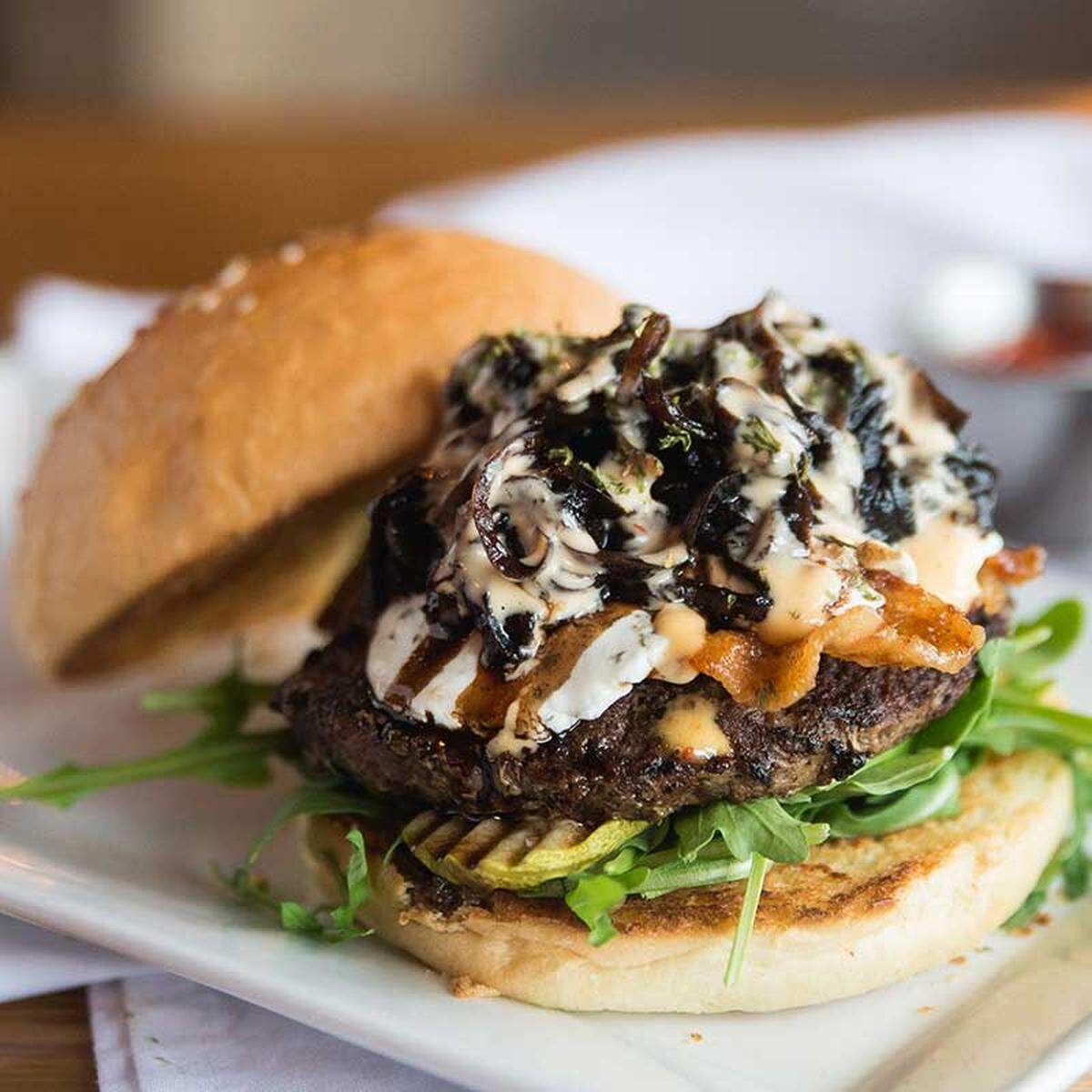 Blacow’s Nutty Goat Burger features a mix of balsamic onions, garlic and herb goat cheese and pecans mix with chipotle aioli, candied bacon, pickle and arugula. In 2018, it was named “best burger in Charlotte” during the Moo and Brew craft beer and burger fest.