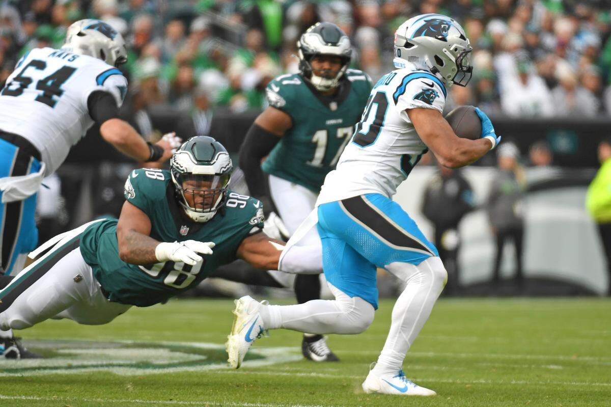 Dec 8, 2024; Philadelphia, Pennsylvania, USA; Carolina Panthers running back Chuba Hubbard (30) runs past Philadelphia Eagles defensive tackle Jalen Carter (98) during the first quarter at Lincoln Financial Field. Mandatory Credit: Eric Hartline-Imagn Images