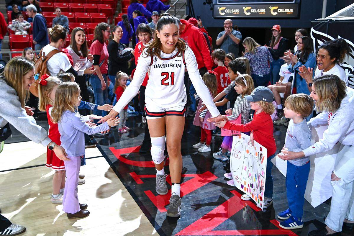 Davidson star Charlise Dunn celebrates with young fans during a game against St. Louis in February.