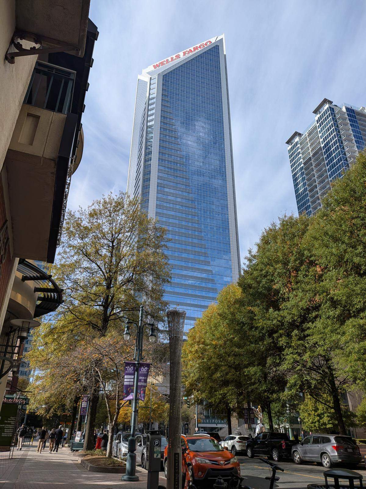 The south view from in front of Wells Fargo Three Center in uptown Charlotte looking toward the San Francisco-based bank’s other corporate offices at 550 S. Tryon St. on Thursday, Nov. 13, 2025. The company added the signs atop the building in June.
