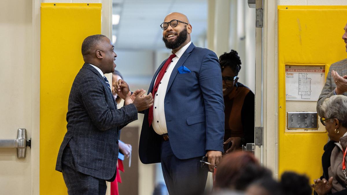 Principal Dwight Thompson, right, arrives at Renaissance West STEAM Academy to be recognized as Charlotte-Mecklenburg Schools’ principal of the year in Charlotte, N.C., on Thursday, November 2, 2023.