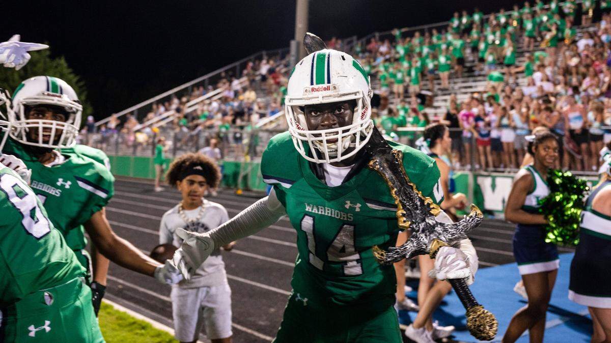Sam Neely, center, celebrates on the sidelines after intercepting a pass against Charlotte Christian during a game on Friday, August 20, 2021 in Weddington, NC. Weddington beat Charlotte Christian with a final score of 14-7.