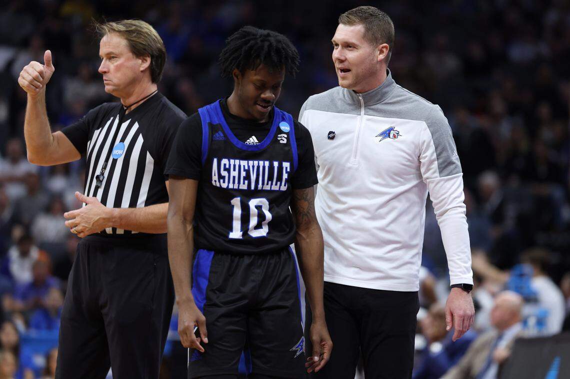 Mar 16, 2023; Sacramento, CA, USA; UNC Asheville Bulldogs head coach Mike Morrell talks to UNC Asheville Bulldogs guard Alex Caldwell (10) in the second half against the UCLA Bruins at Golden 1 Center. Mandatory Credit: Kelley L Cox-USA TODAY Sports
