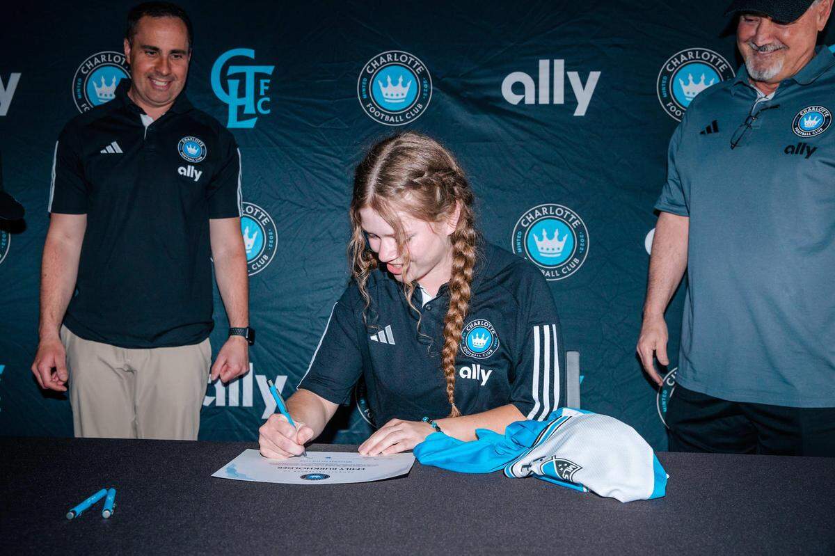 Emily Burkholder signs her Charlotte FC Unified Team contract at Signing Day on April 18, 2023 at Bank of America Stadium.