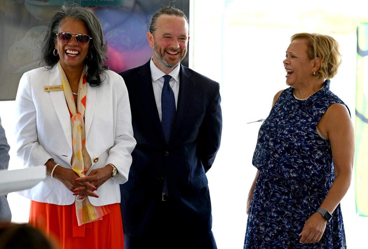 Charlotte City Council members Renee’ Johnson, left, Matt Newton and Mayor Vi Lyles, right, enjoy a moment together during groundbreaking for Eastland Yards. The project will include about 160 single-family homes and 260 apartments, among other components.