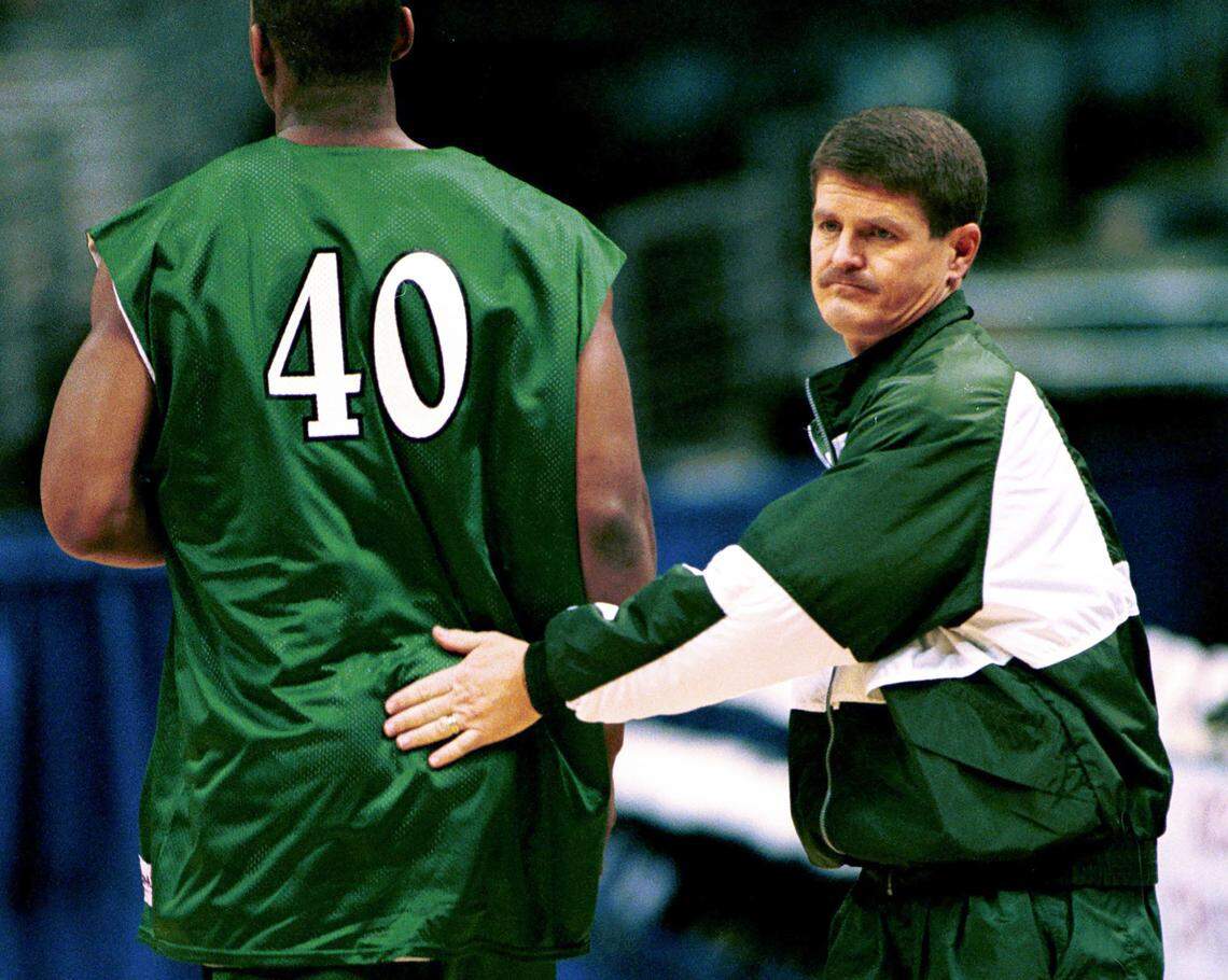 In 1999, head coach Bobby Lutz pats player Tremaine Gardiner during drills before an NCAA tournament game. In Lutz’s first seven years as the Charlotte head coach, his teams made the NCAA tournament five times.