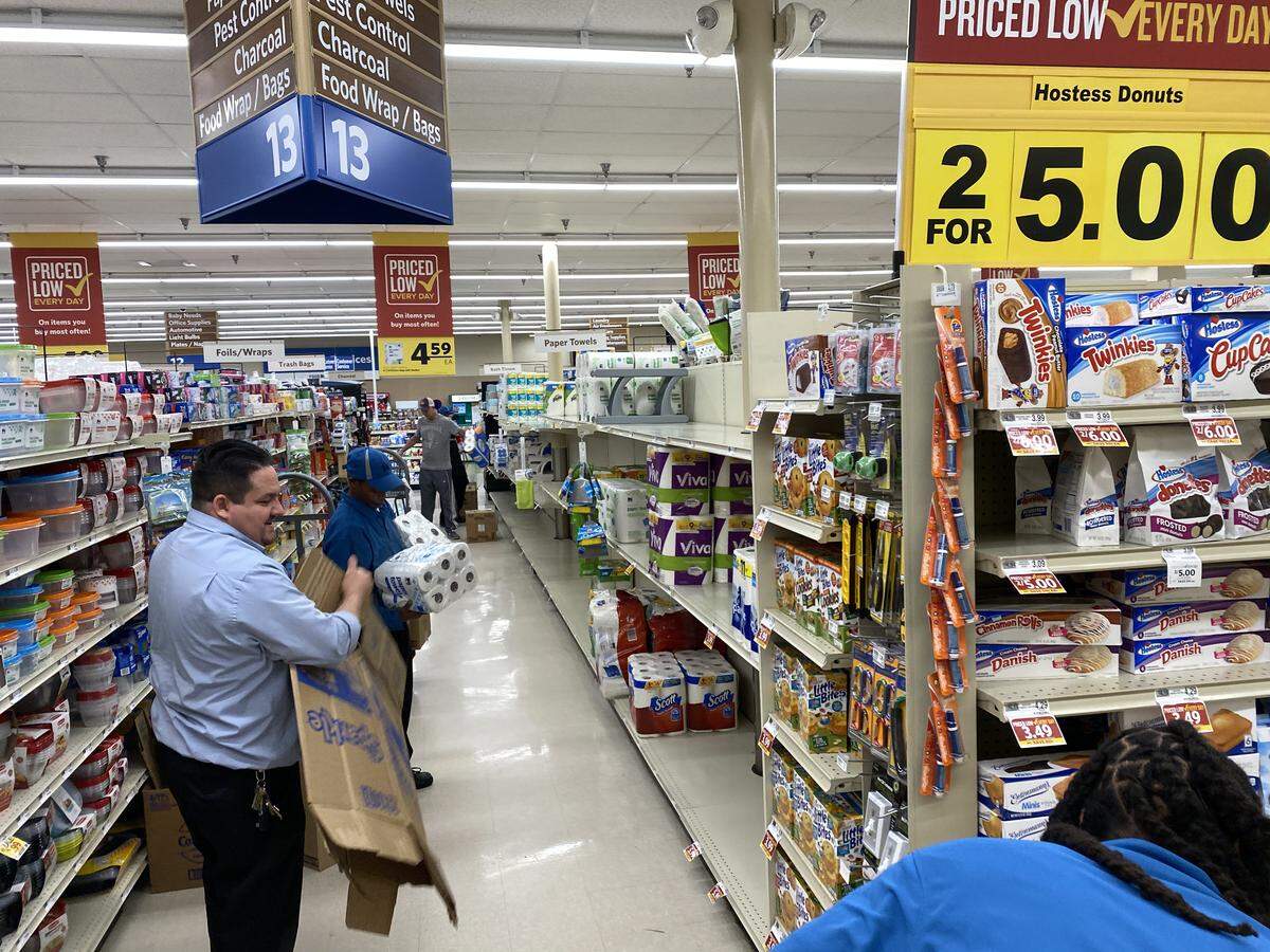 Employees restock shelves at Food Lion on The Plaza on Saturday, March 14, 2020.