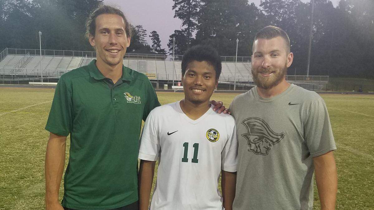 C Van Than, Independence Soccer (center) is shown after breaking the school’s scoring record.  Left to Right: Coach Luke Helmuth, C Van Than, Coach Tyler Gibson.