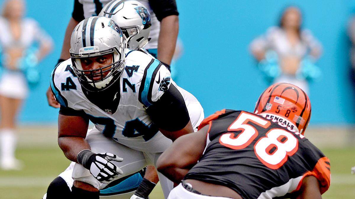 Panthers tackle Chris Clark, center, glances across the line at Bengals defensive end Carl Lawson during Carolina’s 31-21 win on Sept. 23. Clark did not join the Panthers until after their first regular-season game but has played every offensive snap the past two games.