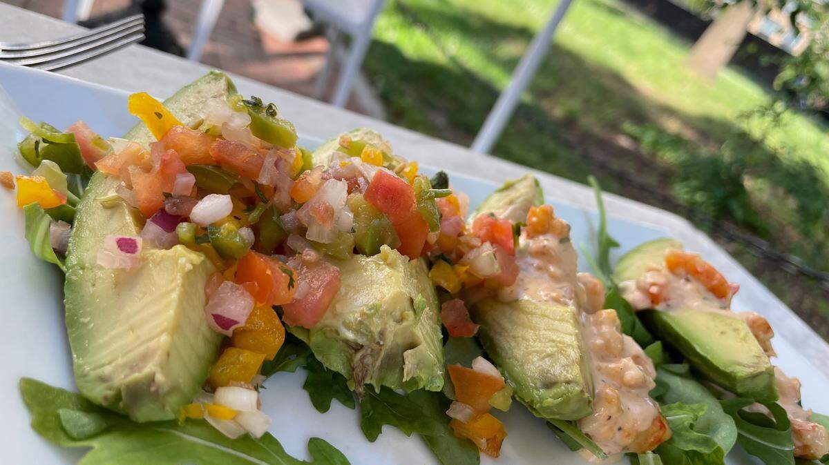 Order Palta Rellena as an appetizer at Poplar: four avocado halves stuffed with tomatoes and pico. In Lima, Peru, Palta Rellenas are served as small bites.