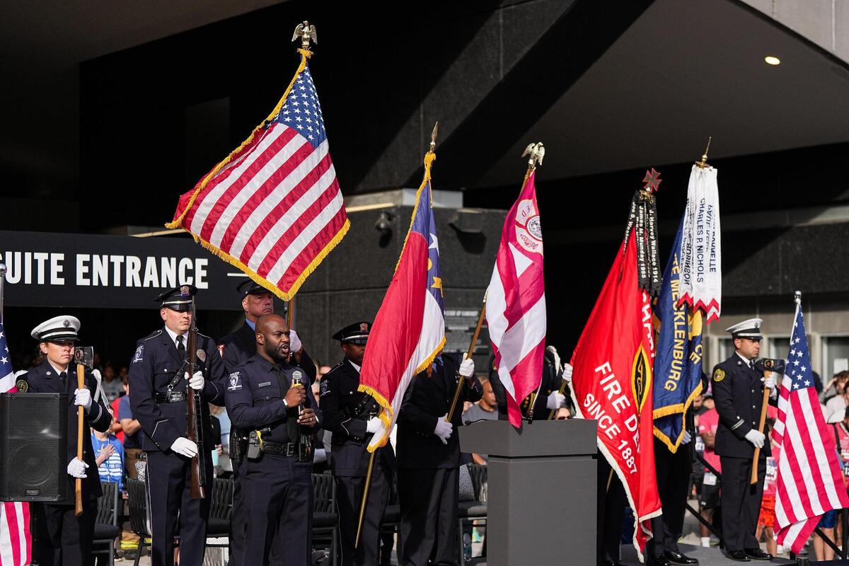 Charlotte-Mecklenburg Police Department officer Kelvin Moore, front, sings the national anthem prior to the Tunnel to Towers Tower Climb at Bank of America Stadium, Sunday, April 27, 2025, in Charlotte.