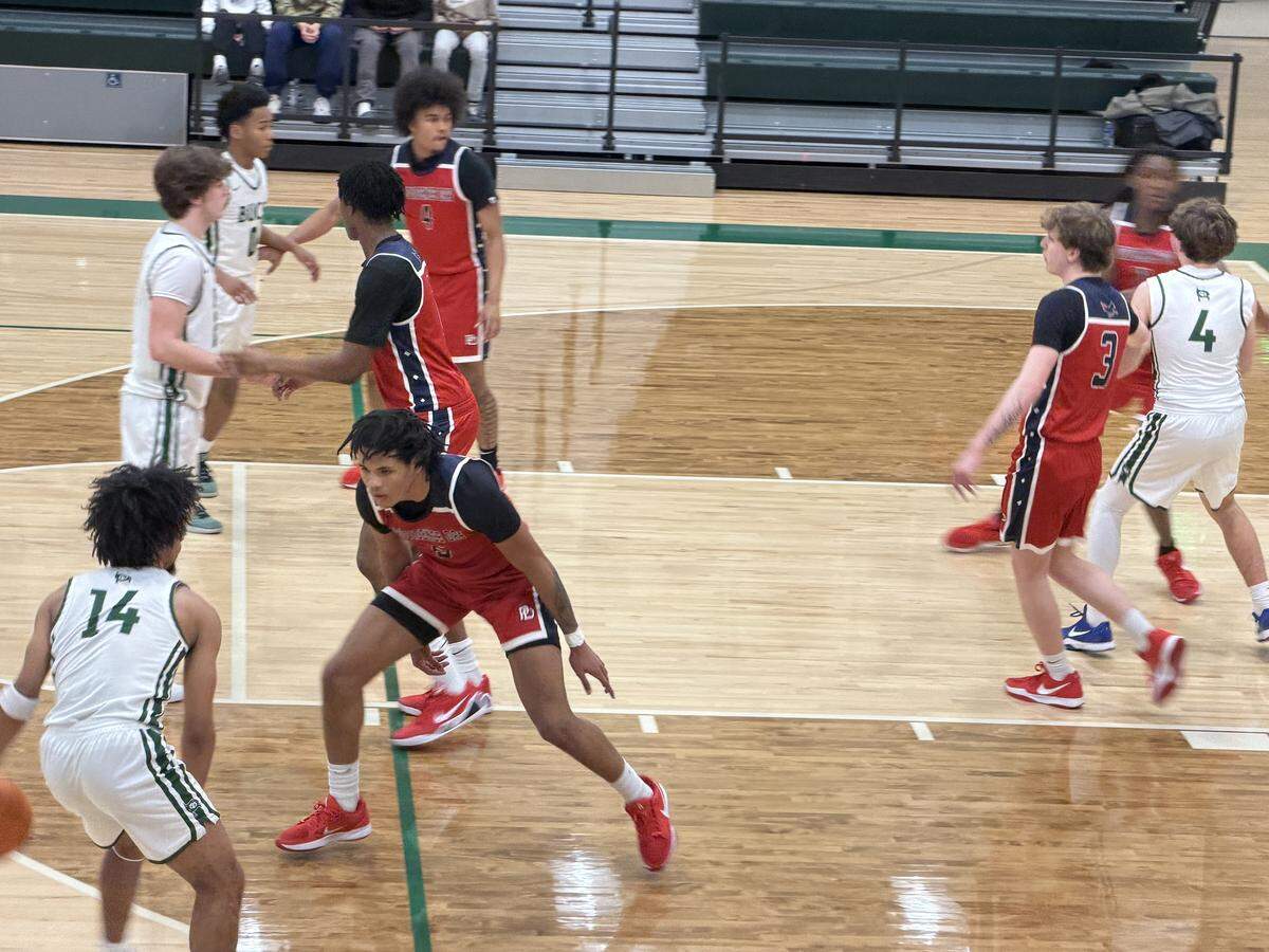 Charlotte Country Day’s Emory Roberts (left) looks for an open teammate during Wednesday’s home game with Providence Day