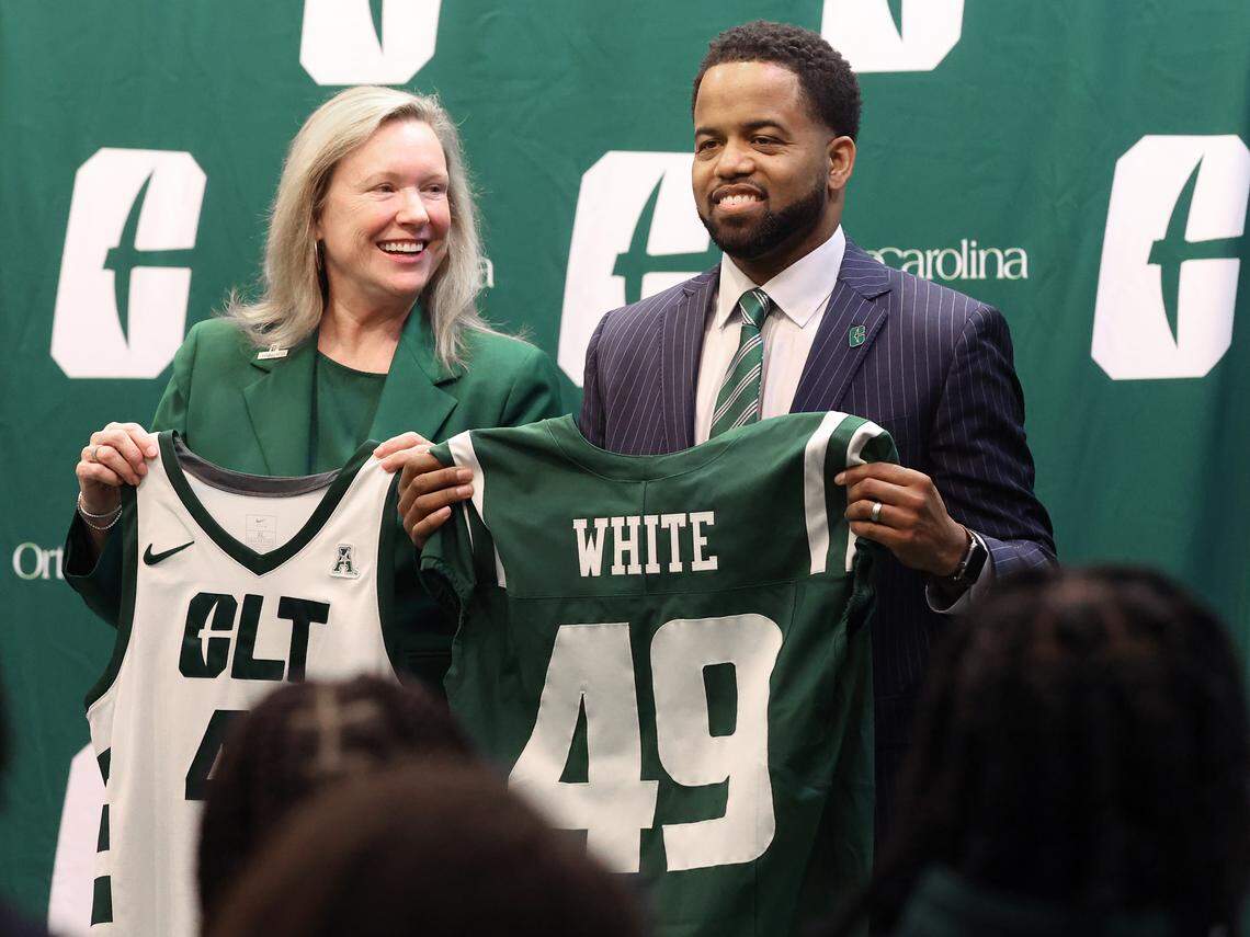 UNC Charlotte Chancellor Sharon Gaber, left, glances over at new Charlotte 49ers athletic director Kevin White during his introductory news conference Thursday. The position opened after Gaber fired former athletic director Mike Hill in October. 