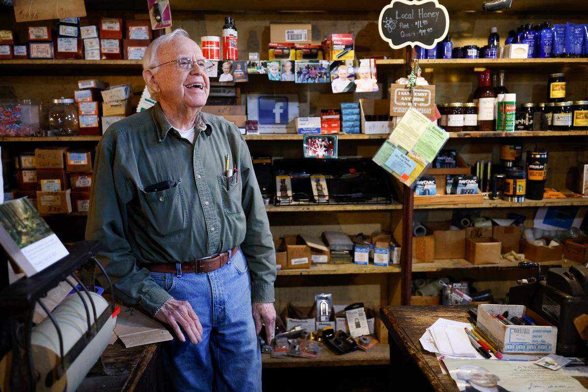Silas Davis, of Charlotte, N.C., owner of the Davis General Store jokes with a Customer who was shopping for seeds to start her yearly garden at the Davis General Store in Charlotte, N.C., Tuesday, April 19, 2022. The store has been run by the Davis family since the late 1800s and been in its currently location since 1908.