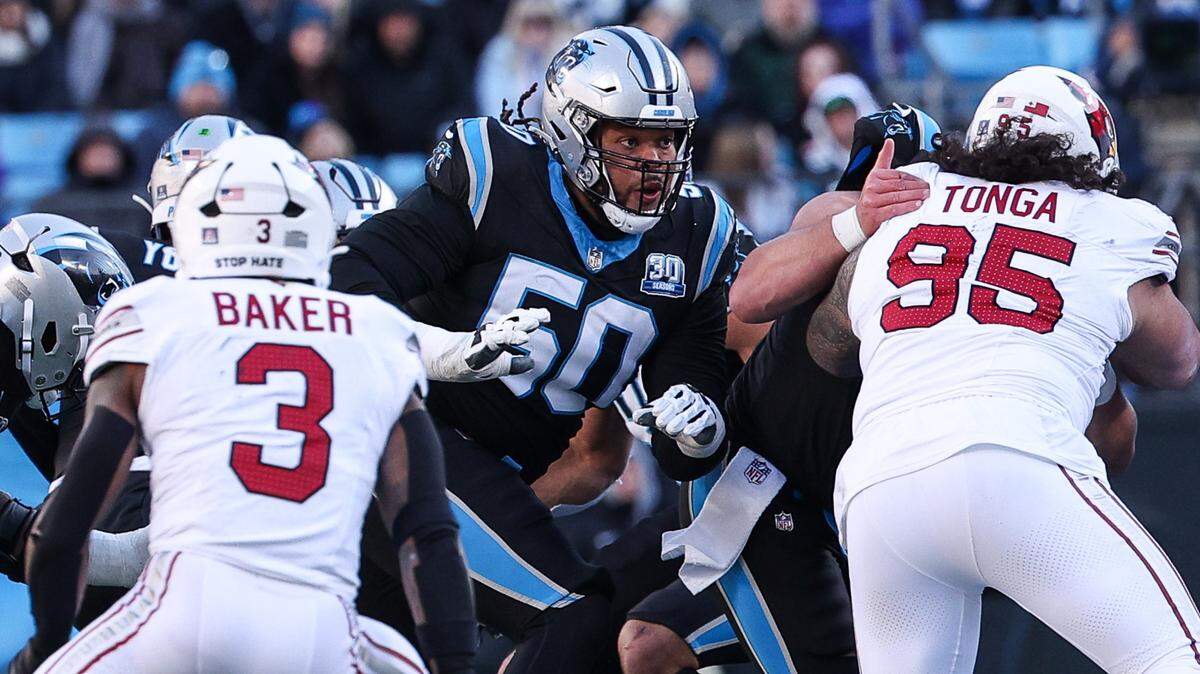 Panthers guard Robert Hunt, center, goes up against the Cardinals defense during the game at Bank of America Stadium in Charlotte, NC on Sunday, December 22, 2024.