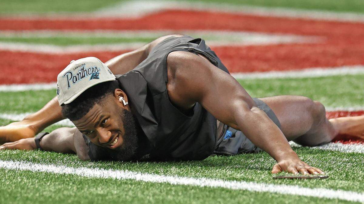 Carolina Panthers linebacker Brian Burns stretches on the turf of the Mercedes-Benz Stadium field in Atlanta, GA on Sunday, September 10, 2023. Burns and the Panthers open the NFL season against the Atlanta Falcons.