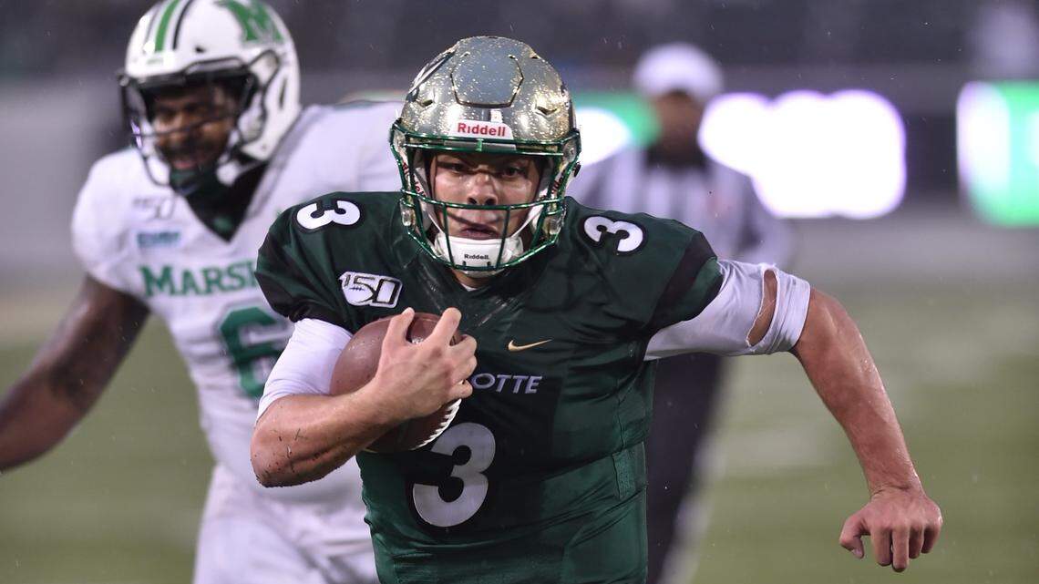 Charlotte 49ers quarterback Chris Reynolds picks up yardage against Marshall on Saturday.