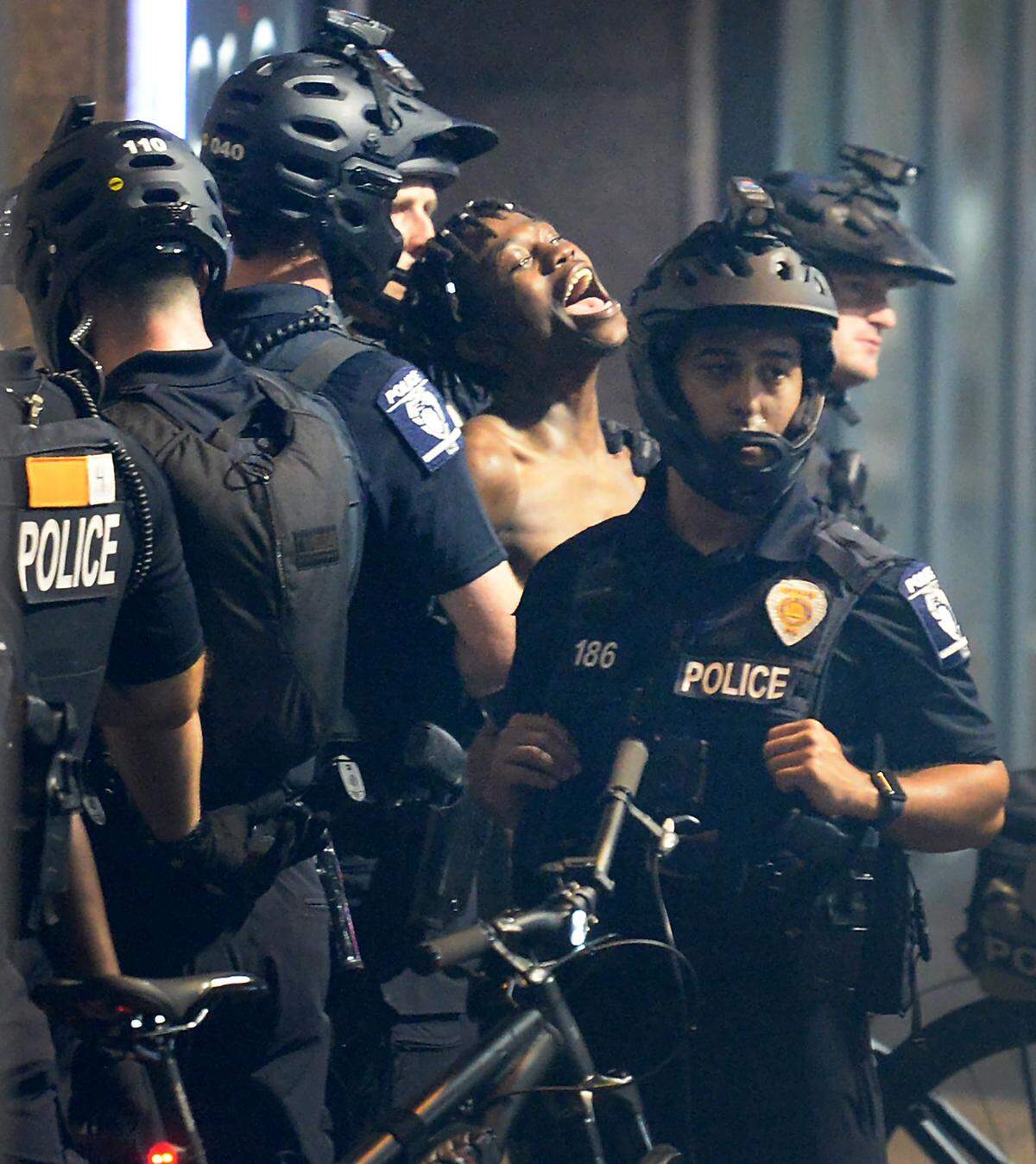 CMPD officers arrest a protester on Trade Street in Charlotte, NC on Sunday, August 23, 2020.