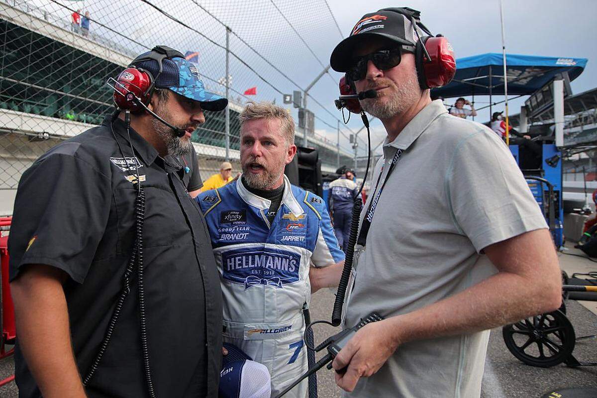 Justin Allgaier, driver of the No. 7 Hellmann’s Spicy Mayo Chevrolet, (center) speaks to crew chief Jim Pohlman (left) and Hall of Famer and JR Motorsports team owner Dale Earnhardt Jr. after an on-track incident during the NASCAR Xfinity Series Pennzoil 250 at Indianapolis Motor Speedway on July 26, 2025.