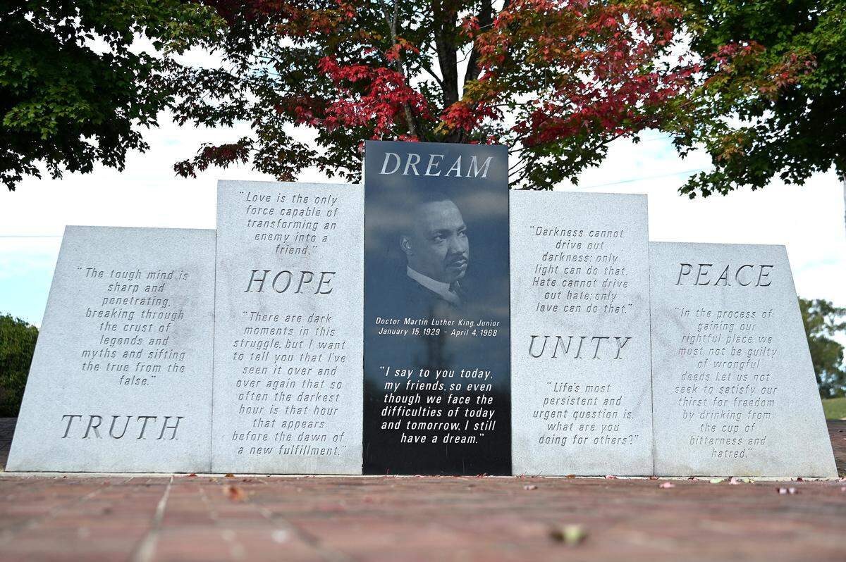 Graffiti is faintly visible on panels of the Dr. Martin Luther King Jr. monument on Cabarrus Avenue in Concord, on Monday, October 9, 2023. Over the weekend the monument was vandalized. The Concord Police Department is investigating and city crews worked to restore the monument.