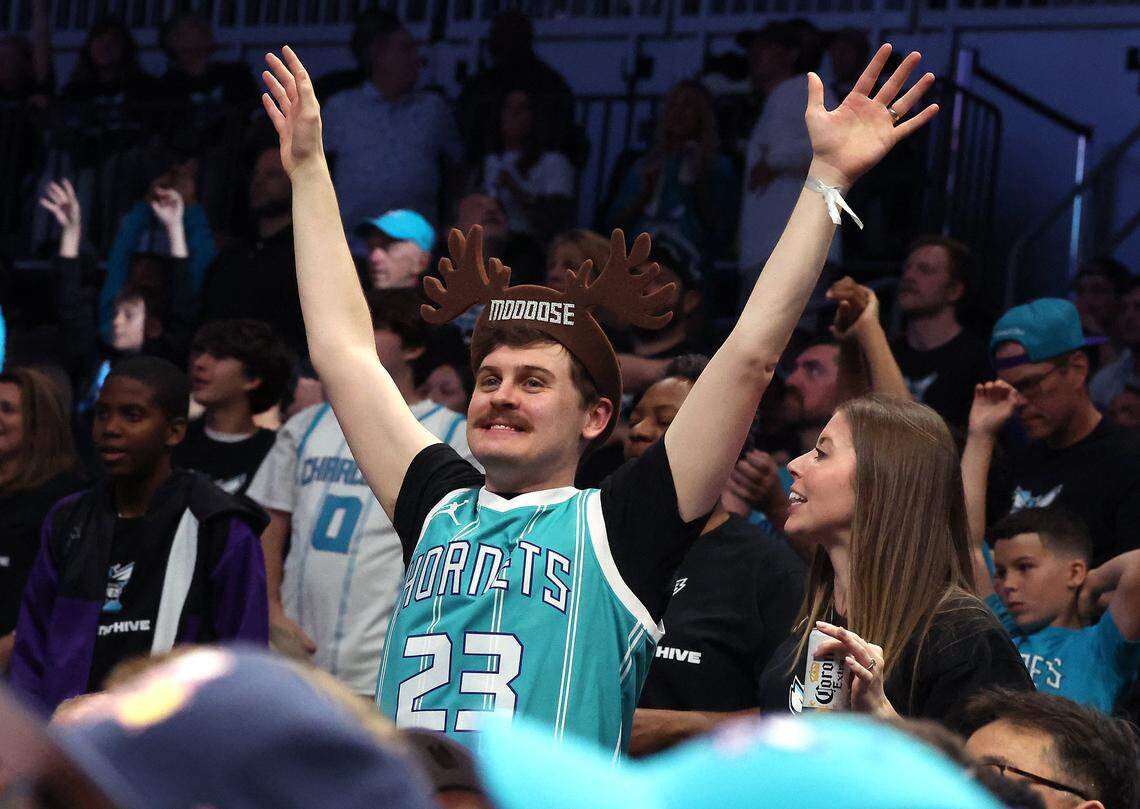A Charlotte Hornets fan enjoys the team's game against the Miami Heat at Spectrum Center in Charlotte, NC on Tuesday, April 14, 2026. The Hornets defeated the Heat 127-126 in NBA Play-in-Tournament basketball game.