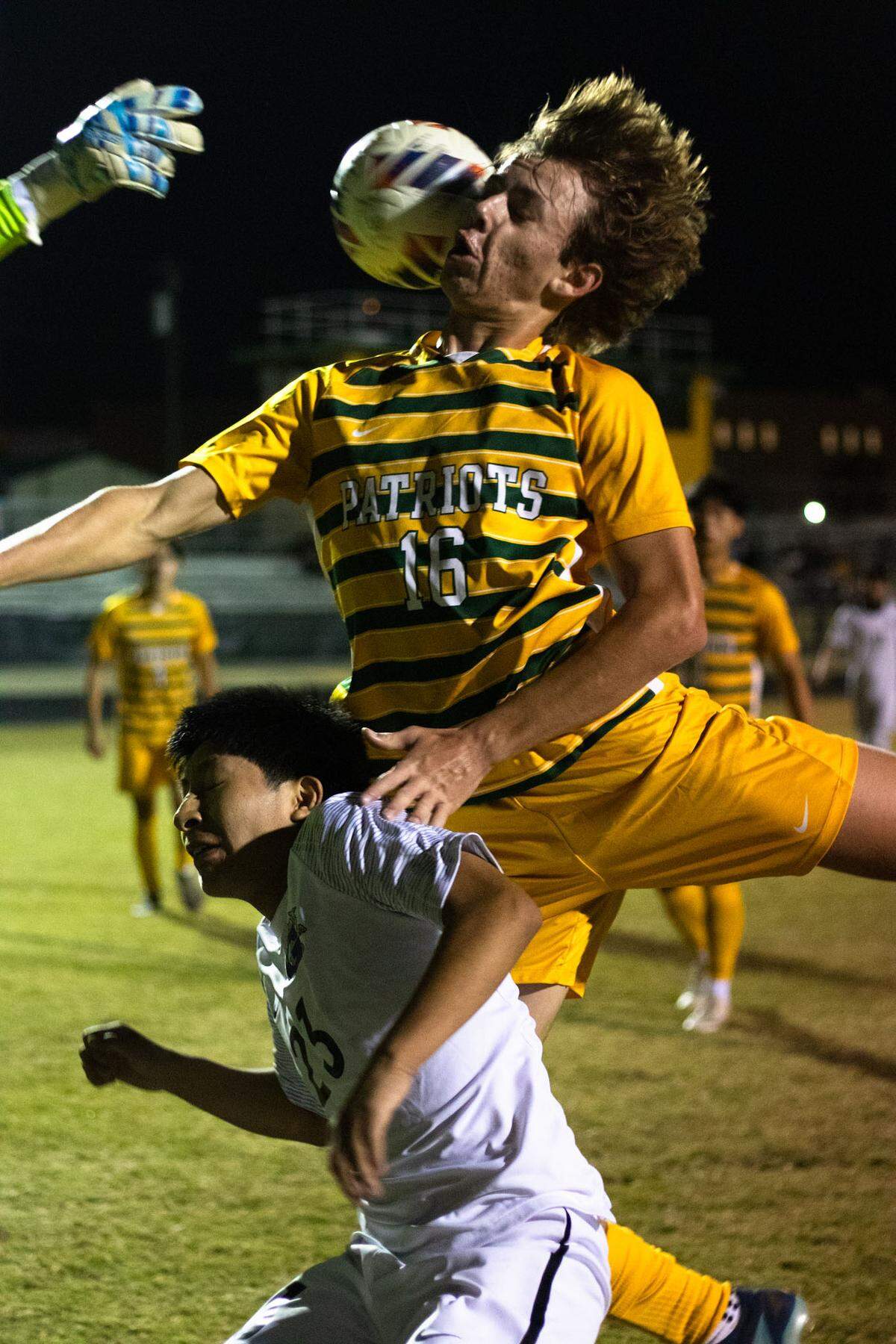 Title: brutal box Independence Soccer player goes in rough for the corner kick, jumping over garinger defense and making contact with the ball face first. 10-22-24