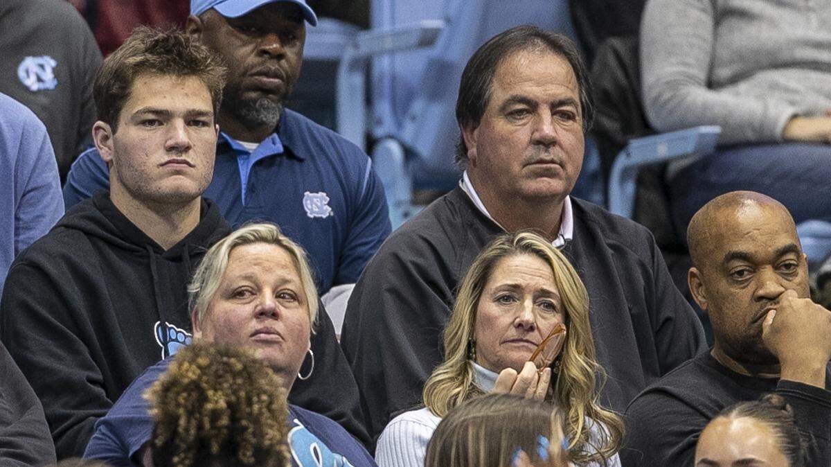 North Carolina quarterback Drake Maye (left) and his father Mark Maye watch the second half of a UNC basketball game in 2022, while Drake was still the QB at UNC.