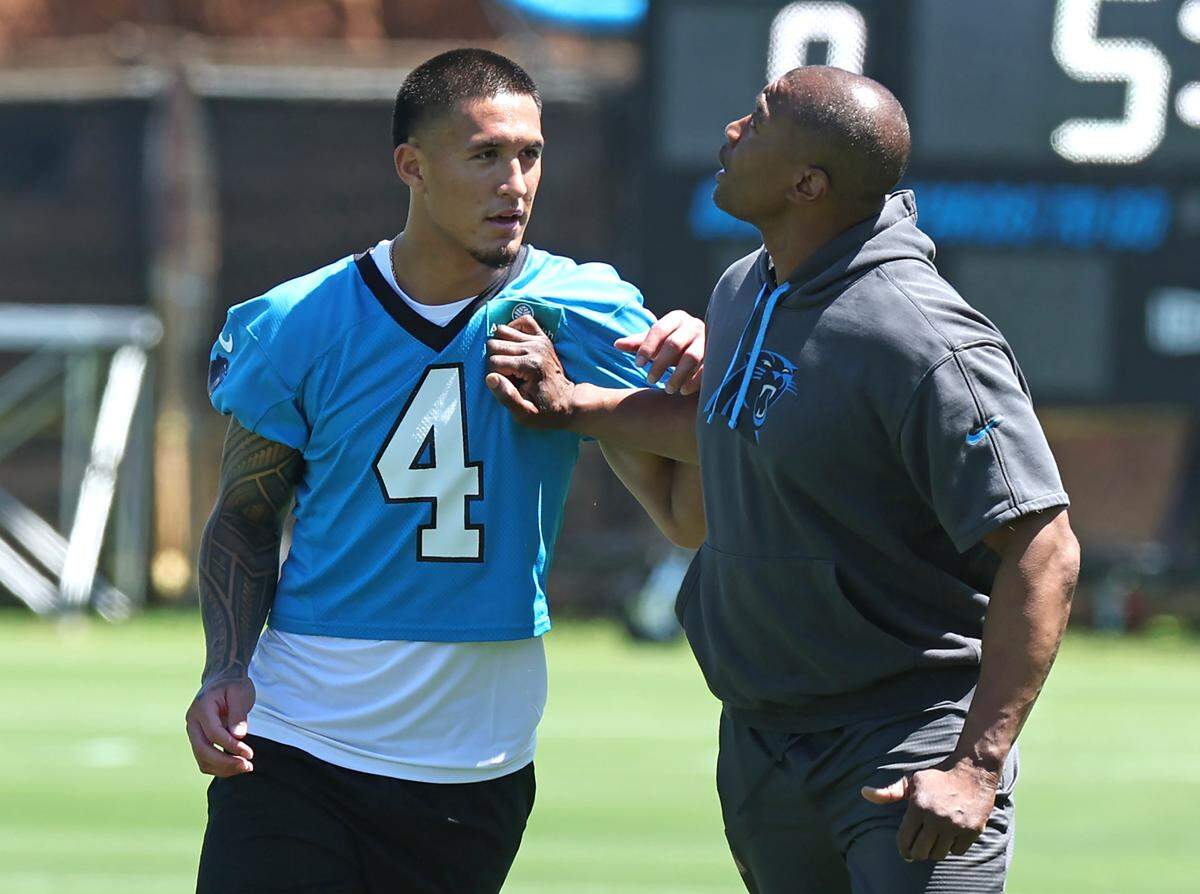 Carolina Panthers rookie wide receiver Tetairoa McMillan, left, receives technique help from wide receivers coach Rob Moore, left, during the team’s rookie minicamp practice on Friday, May 9, 2025.