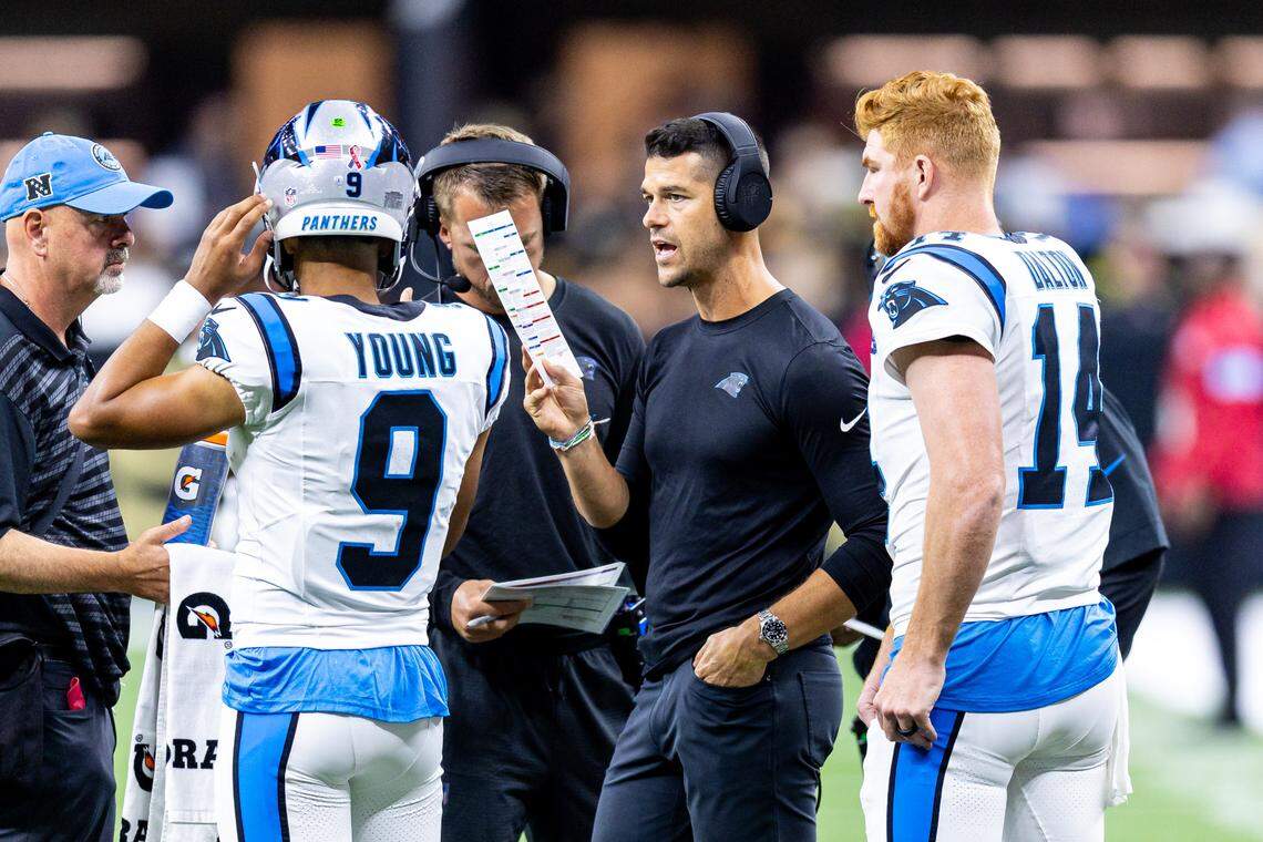 Carolina Panthers head coach Dave Canales talks to quarterback Bryce Young (9) and quarterback Andy Dalton (14) on a time out against the New Orleans Saints during the first half at Caesars Superdome.