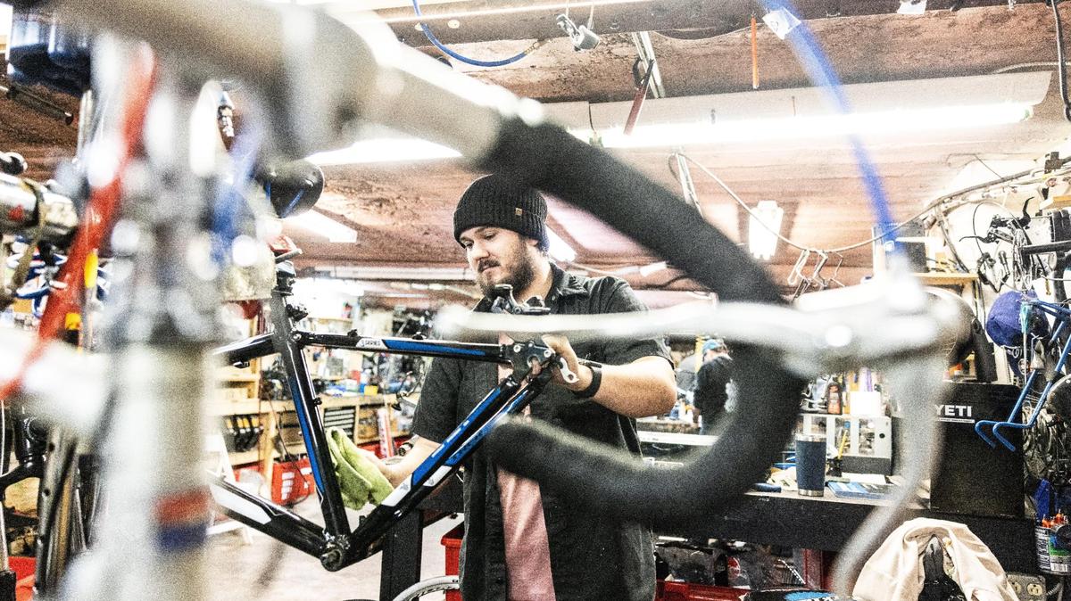 Gage Sanders works on a bike at Trips for Kids Charlotte in Charlotte.