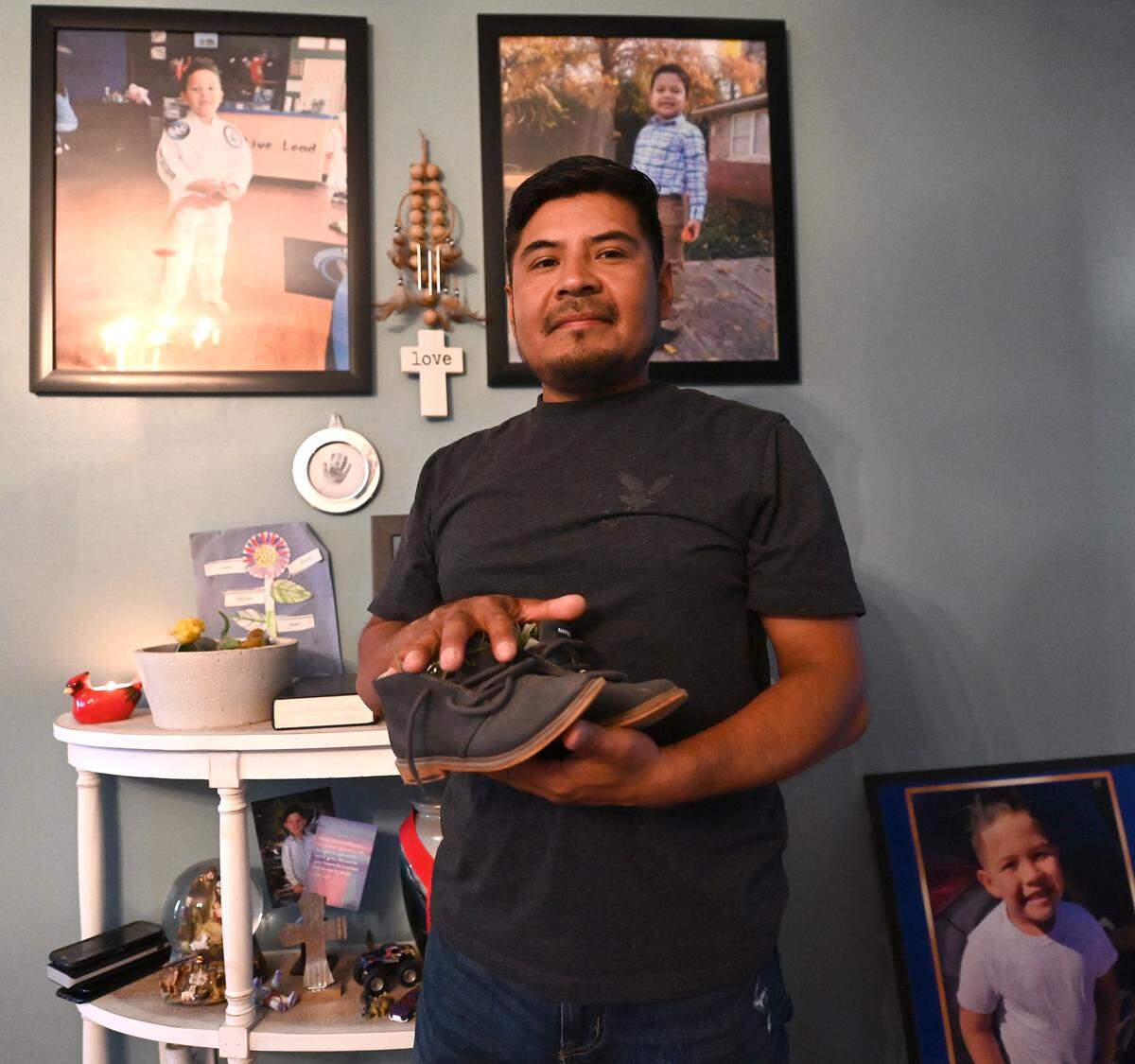 Santiago Lagunas holds his son Liam Lagunas’ shoes at his home in Gastonia, NC.,, on Tuesday, August 19, 2025. Six-year-old Liam lost his life in a crash caused by street racing in 2021. In response to this senseless loss, NC Governor Josh Stein signed Liam’s Law, which aims to enhance penalties for reckless driving and street racing that result in serious injuries or fatalities. 