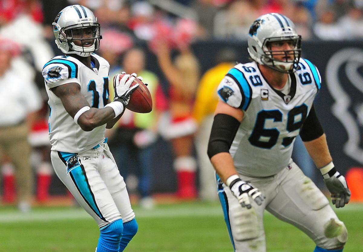 (L-R) Carolina Panthers wide receiver Armanti Edwards (14) looks to pass to wide receiver Steve Smith (89) as tackle Jordan Gross (69) provides protection vs the Houston Texans during second quarter action Sunday, December 18, 2011 at Reliant Stadium in Houston Texans. The Panthers defeated the Texans 28-13. Jeff Siner - jsiner@charlotteobserver.com