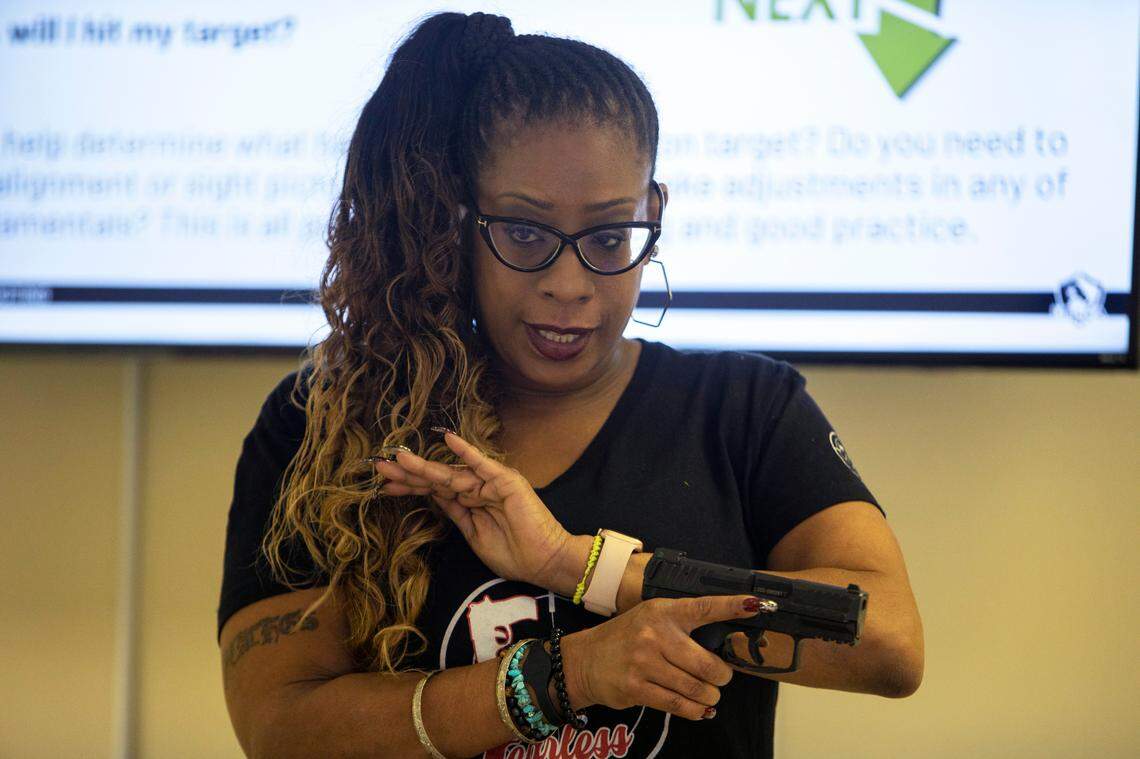 LaToya Workman shows her class how to rack the slide of a handgun back in Charlotte, NC Saturday August 13, 2022.
