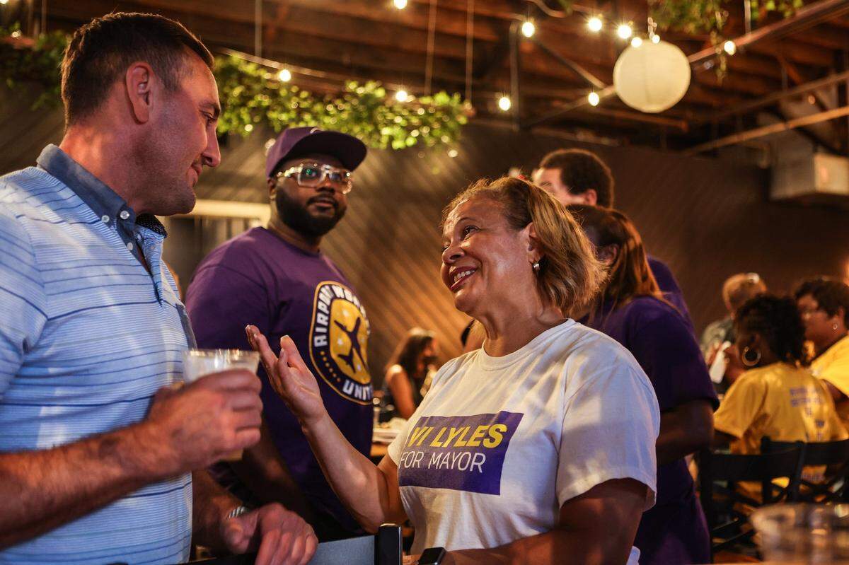 Mayor Vi Lyles, left, speaks with a supporter a post-election watch party at Heist Brewery on Tuesday, July 26, 2022 in Charlotte, NC. 