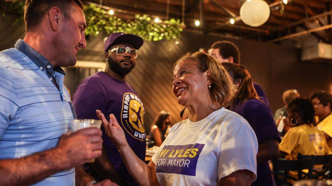 Mayor Vi Lyles, left, speaks with a supporter a post-election watch party at Heist Brewery on Tuesday, July 26, 2022 in Charlotte, NC.