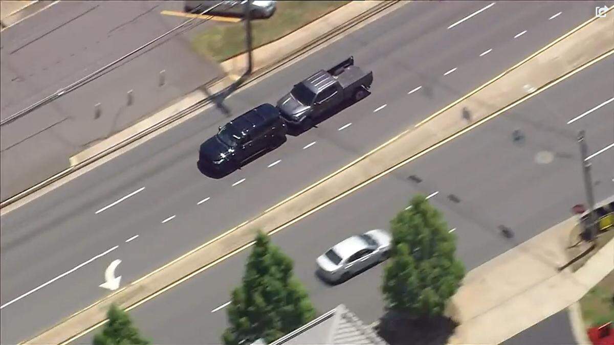 In this image from WSOC video, a gray Toyota Tundra driven by Abrahan Nassar rams the back of a black Infiniti SUV on Park Road during a police pursuit in Charlotte, NC, on Wednesday, July 6, 2022.