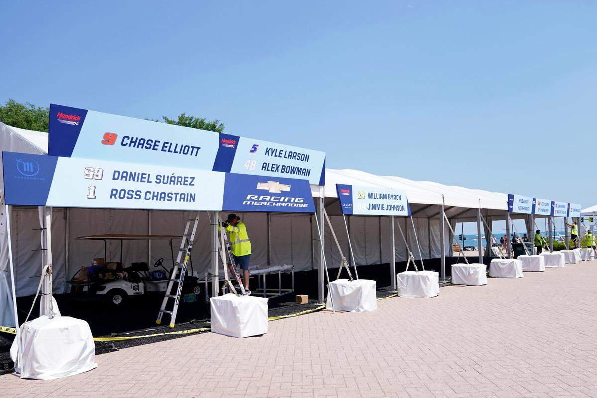 Jun 24, 2023; Chicago, Illinois, USA; A general view of workers installing vendor stands near Buckingham Fountain before the Chicago Street Race. Mandatory Credit: Jon Durr-USA TODAY Sports