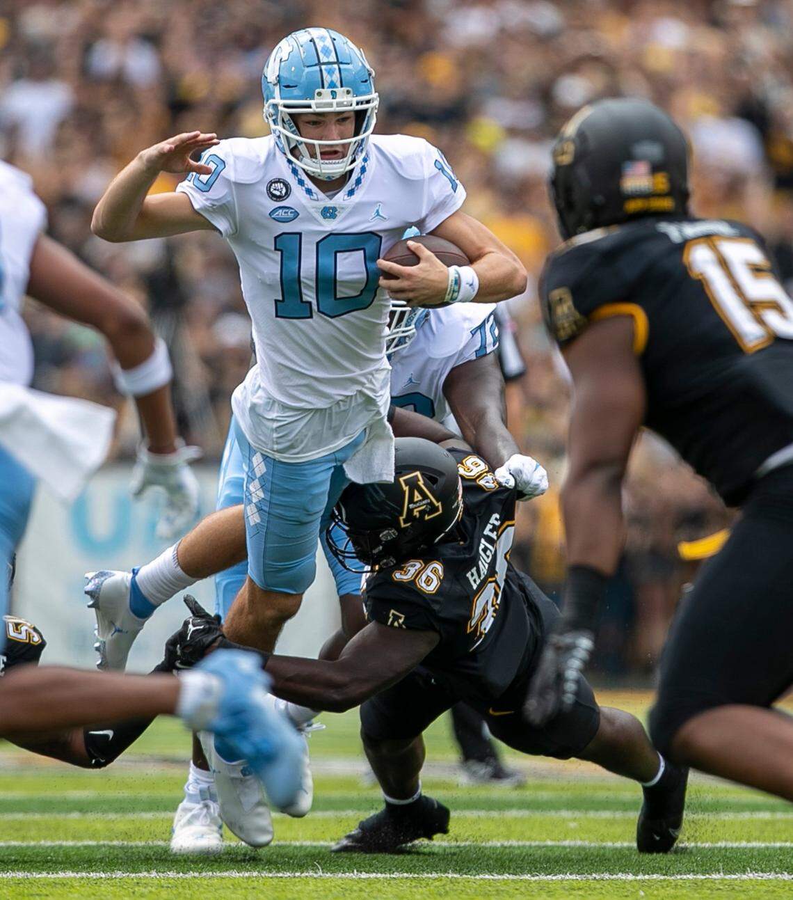 North Carolina quarterback Drake Maye (10) rushes for four yards on a fourth-and-3 before being stopped by Appalachian States Kevon Haigler (36) in the first quarter on Saturday, September 3, 2022 at Kidd Brewer Stadium in Boone, N.C.