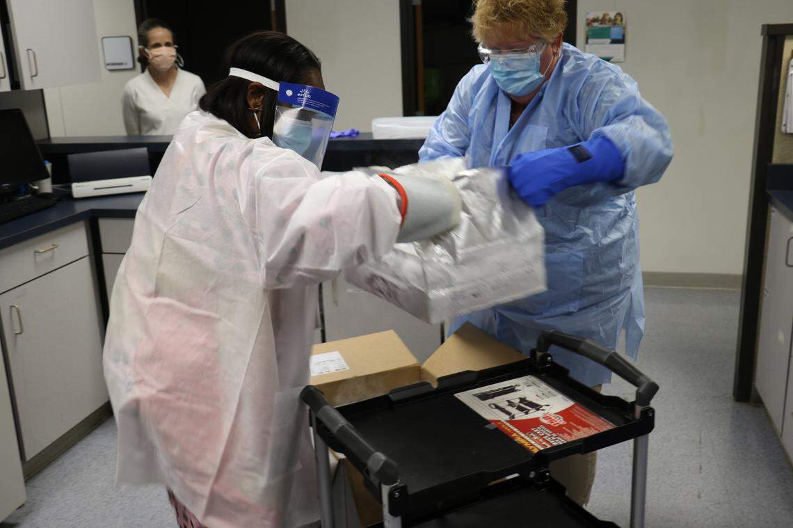 Employees at Mecklenburg County Public Health with doses of the Pfizer BioNTech COVID-19 vaccine delivered Wednesday, Dec. 23, 2020.