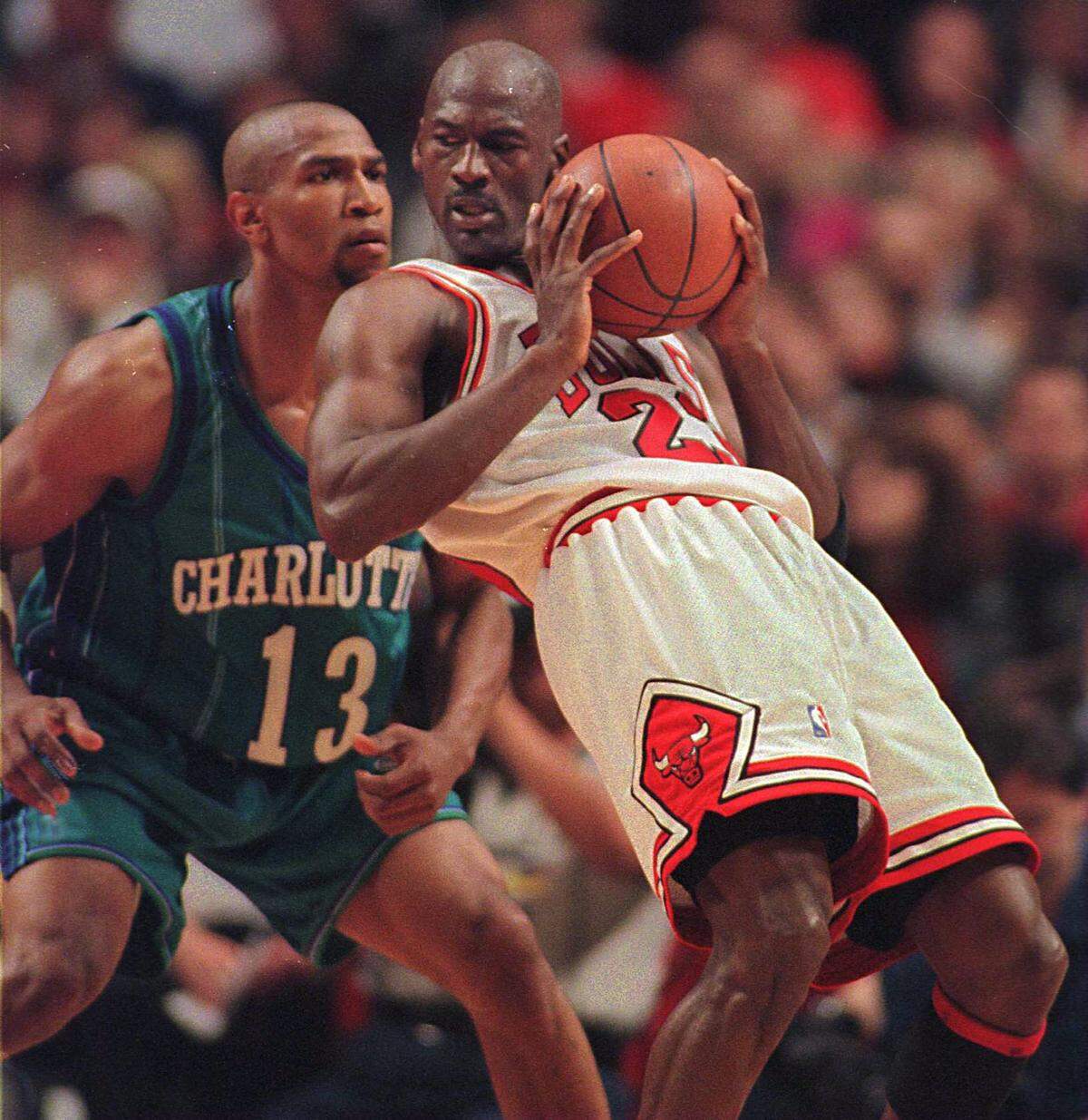 Future Charlotte Hornets owner Michael Jordan creates some room against the Hornets’ Bobby Phills in the 1998 playoff series between the Chicago Bulls and the Hornets. Phills died in a car crash in 2000.