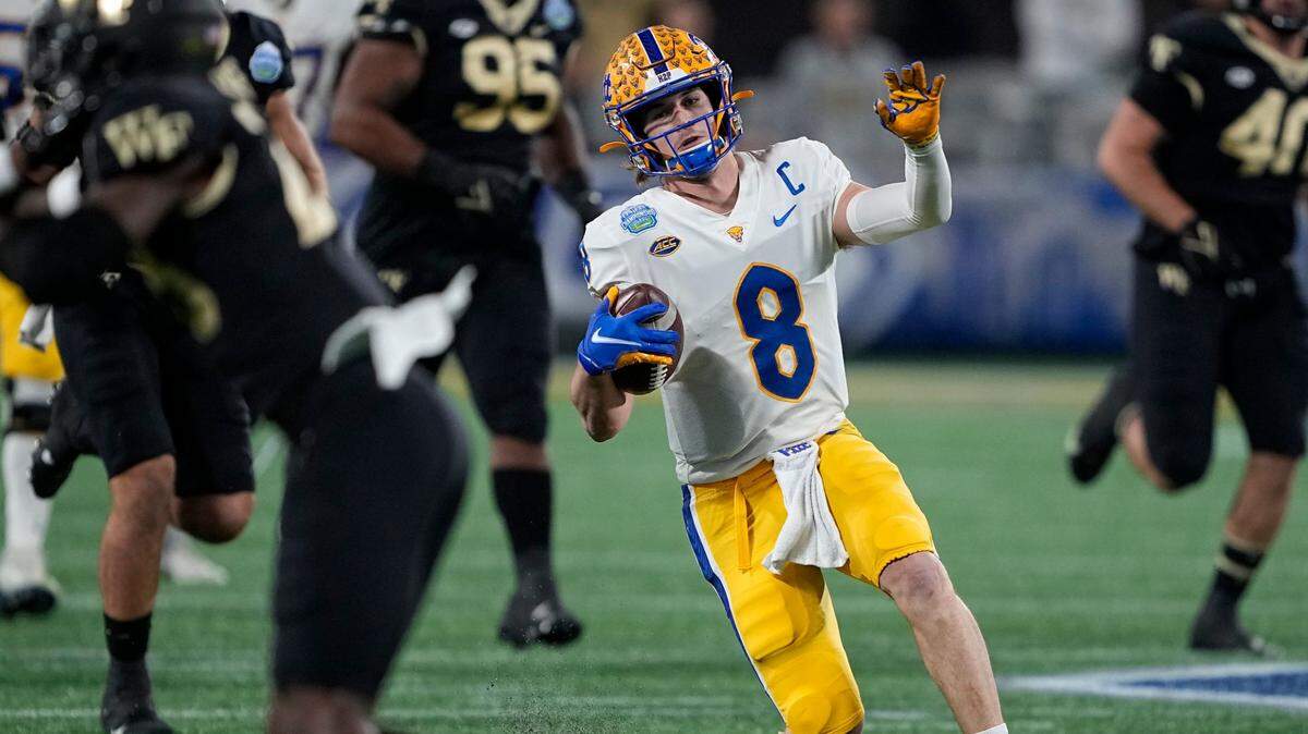 Pittsburgh quarterback Kenny Pickett fakes a quarterback slide, digging his right toe into the artificial turf as if he is going down, before rising back up and finishing a 58-yard touchdown run against Wake Forest during the first quarter of the Atlantic Coast Conference championship NCAA college football game Saturday, Dec. 4, 2021, in Charlotte, N.C. Pitt won, 45-21.