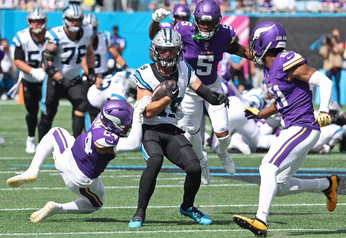 Carolina Panthers wide receiver Adam Thielen, center, attempts to avoid the collapsing Minnesota Vikings defense following a pass reception during second quarter action at Bank of America Stadium on Sunday, October 1, 2023.