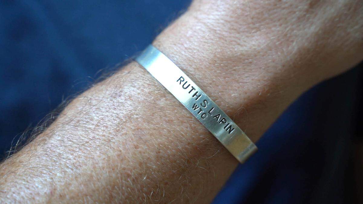 In the first year after 9/11, Doug Schroeder received a silver bracelet in the mail from a congregation wanting to reach out to the living victims. The bracelet is engraved with his mother’s name and WTC.