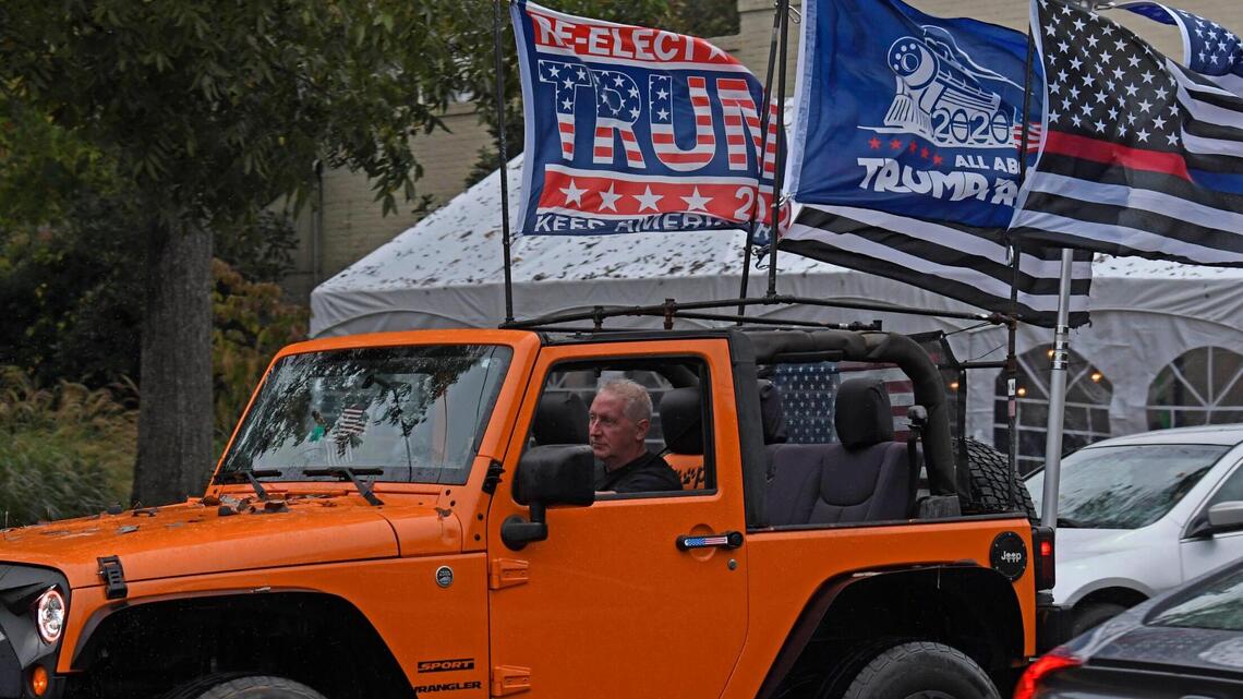 He flies Trump flags out of an orange Jeep, in a town where you might not expect it