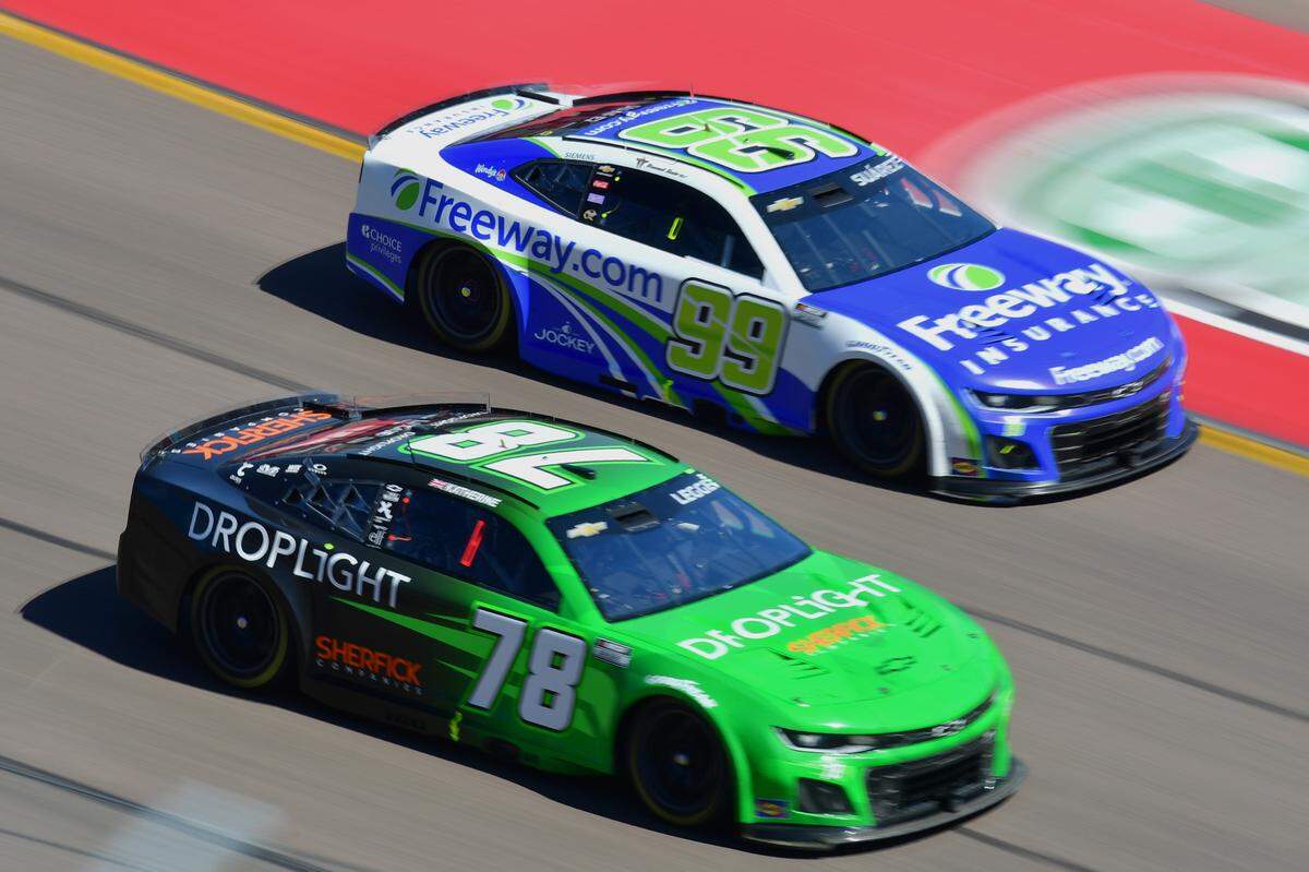 Mar 9, 2025; Avondale, Arizona, USA; NASCAR Cup Series driver Daniel Suarez (99) drives alongside driver Katherine Legge (78) during the Shriners Children’s 500 at Phoenix Raceway.