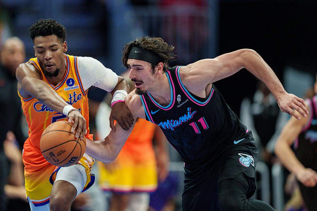 Brandon Miller of the Charlotte Hornets and Jaime Jaquez Jr. of the Miami Heat go for the ball in the second half during their game at Spectrum Center.
