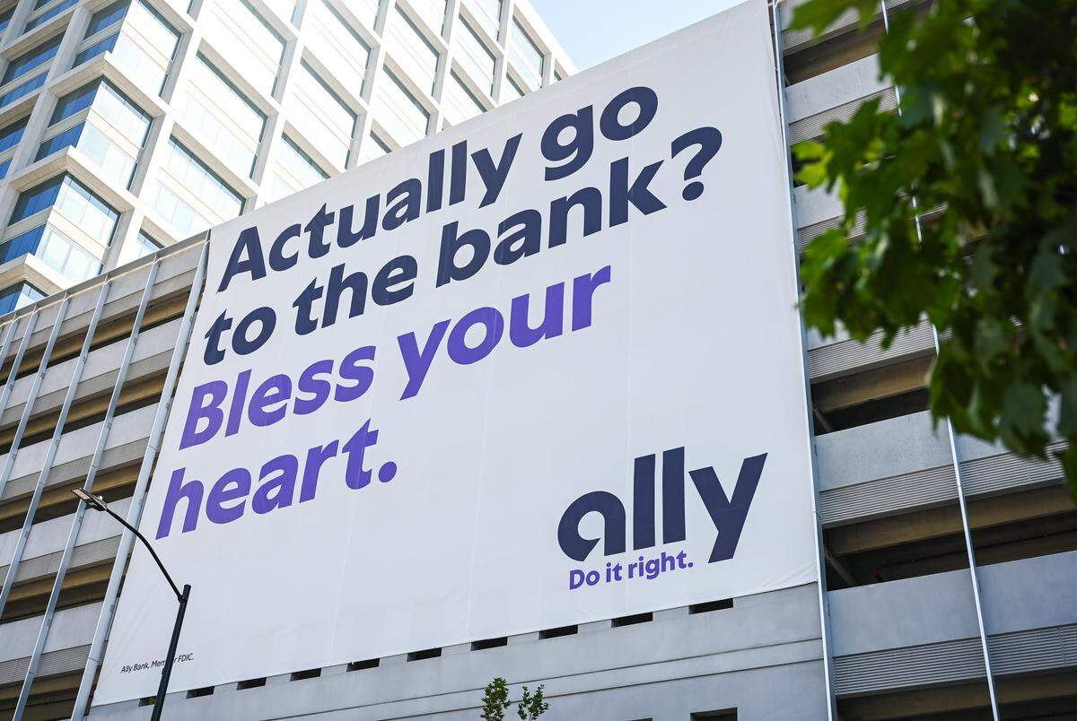 A large sign is displayed on the side of the Ally Bank parking deck facing East Good Samaritan Way on Wednesday, May 20, 2026.