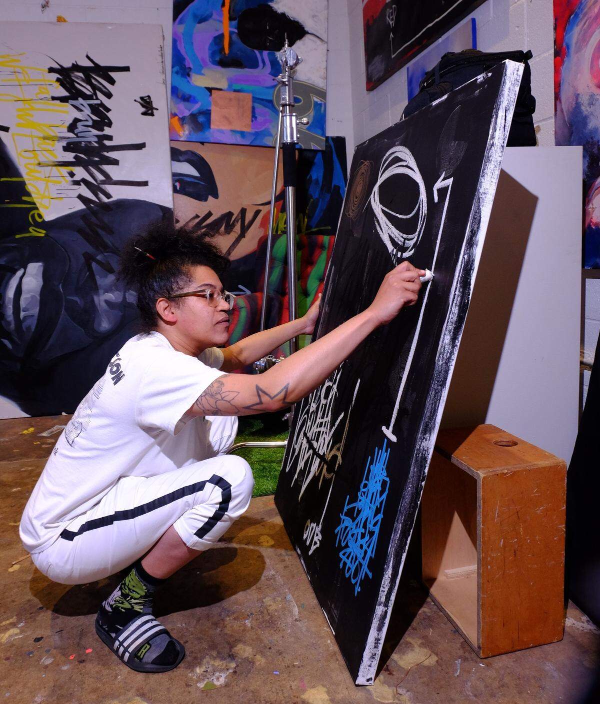Charlotte artist Carla “King Carla” Aaron-Lopez works on “Ode to ODB” in her studio. The piece will be part of the LOCAL/STREET pop-up art show she is curating in March at Mint Museum Randolph, which will showcase more than 40 local artists of color. 