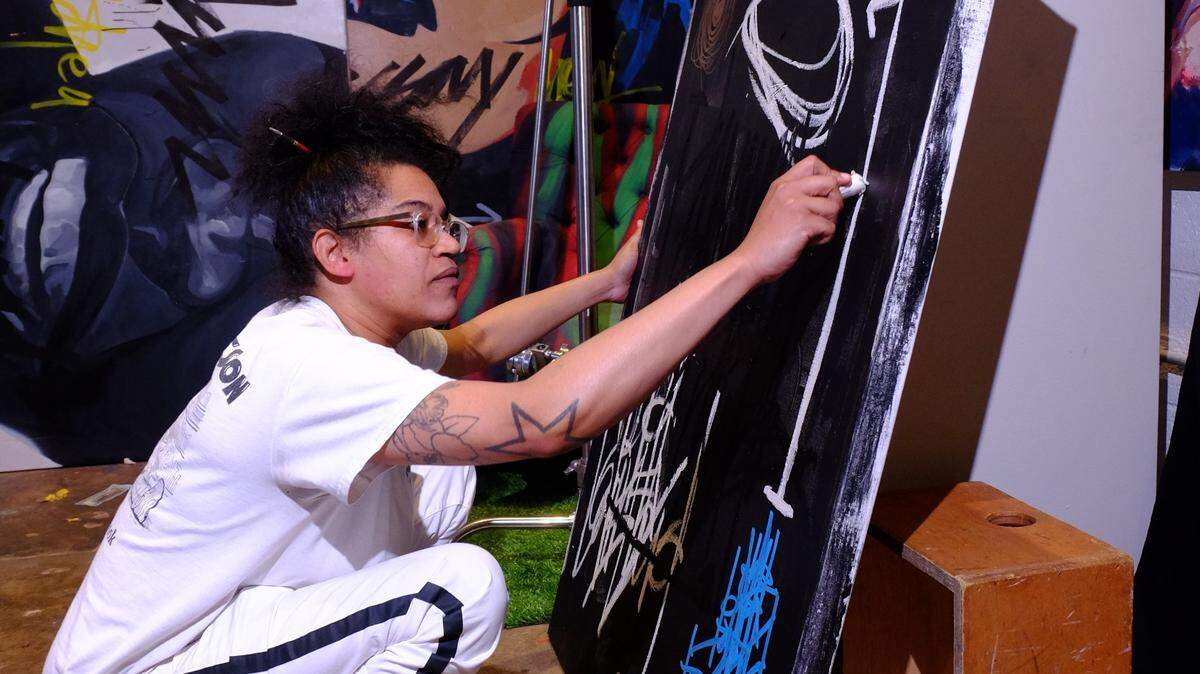 Charlotte artist Carla “King Carla” Aaron-Lopez works on “Ode to ODB” in her studio. The piece will be part of the LOCAL/STREET pop-up art show at the Mint Museum that she curated. The exhibition will showcase the work of more than 40 local artists of color.